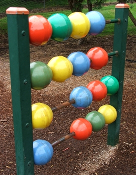 Featured is a photo of a giant, colorful outdoor abacus ... a learning tool and a piece of play equipment ... perfect for preschool-kindergarten level kids.  Photo by Kym McLeod of Cann River in Victoria, Australia.